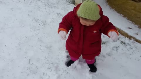 Baby's first steps in the snow result in an adorable fail