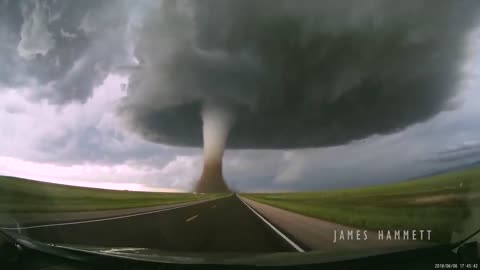 Storm chasing dashcam: Tornado crossing the highway! Laramie, Wyoming