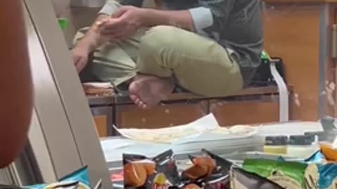 a man making a sandwich barefoot on a #Subway counter in #Chicago.