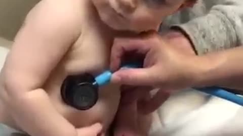 Adorable baby boy cuddles on nurse