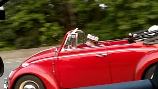 Mask wearer in a convertible at Interstate Speeds