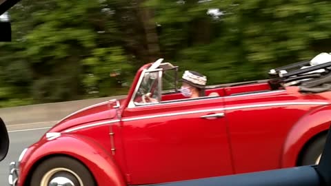 Mask wearer in a convertible at Interstate Speeds