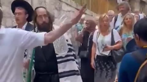 Ultraorthodox Jews spit towards Christian pilgrims leaving Church of the Flagellation.