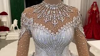 THIS STUNNING WEDDING DRESS WAS HANDMADE AND HAS OVER 200,000 CRYSTALS