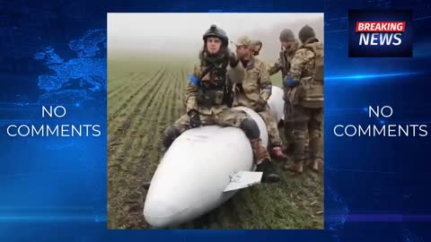 Ukrainian troops pose for a video by sitting on an unexploded bomb