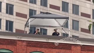 On one of the rooftops across from the main entrances to the Trump rally today