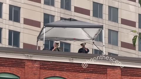 On one of the rooftops across from the main entrances to the Trump rally today
