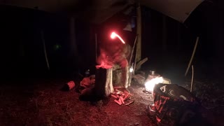 GoPro night lapse .Making a campfire underneath a tarp in a woodland