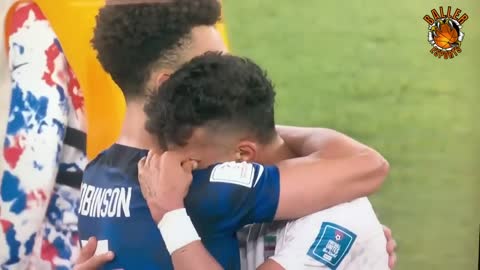 Antonee Robinson embraces the distraught Ramin Rezaeian at full time. USA vs Iran.