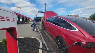 Tesla model X with dead battery stuck on flatbed at supercharger