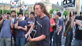 Anti War protester sings to riot police (2008) Parliament Square, Westminster, London