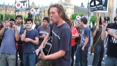 Anti War protester sings to riot police (2008) Parliament Square, Westminster, London