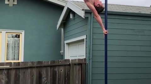 Guy Shows Amazing Balance Skills While Performing Handstand Hops On a Pole