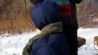 Baby can't make up his mind about sledding