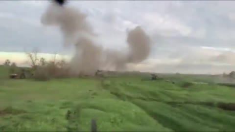 A column of armored vehicles HMMWV breaks through under fire