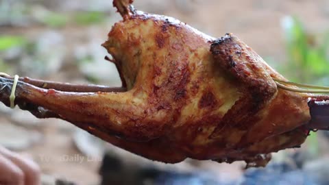 The girl Cooking Chicken in the forest