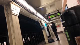 Man doing make up on subway platform