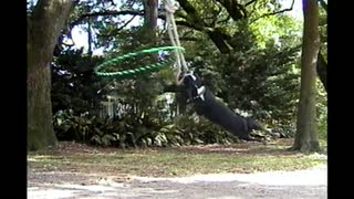 Dog Hula Hoops While Swinging On A Rope