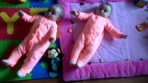 twin baby girls dance-kicking