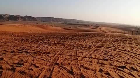 Motor riding in red sand desert of Saudi Arabia