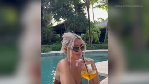 Kim Kardashian indulges in a drink as she promotes headphones