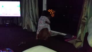 Cute baby rides boxer dog like a horse