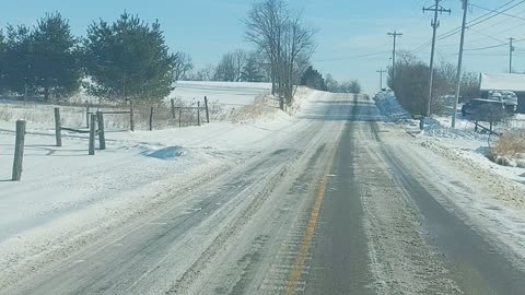 Driving down snowy county road