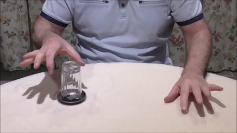 A Coin Strangely Enters An Upturned Glass