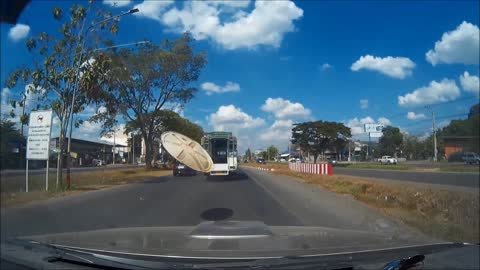 Garbage Bin Cover Flies Into Front Of Car