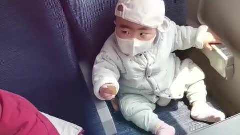 Intelligent kid-baby removing the mask and putting it back again.