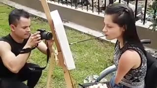 disabled woman painting with her mouth