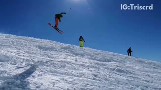 Skier does backflip over hill and lands sideways into snow