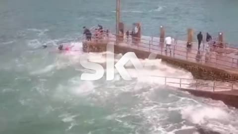 girl is swept into the sea by huge wave