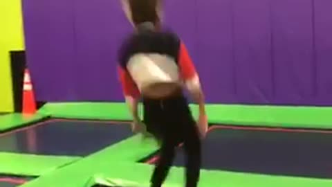 Girl does front flip on trampoline and slams face into safety pad