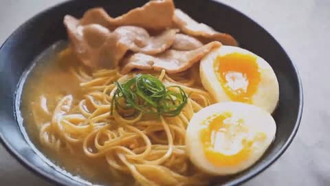 A bowl of steaming beef noodles on the table