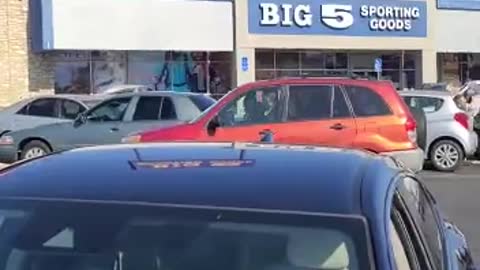 Woman Climbs Onto Car as Couple Argue