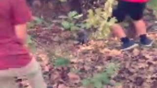 Red shorts hoodie kid falls down hill in woods