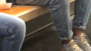 A man draws a sketch on subway train