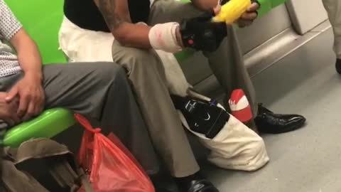 Man in hat eats corn on the cob in china