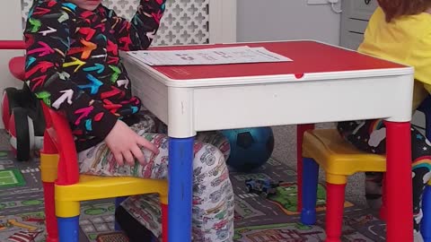 Siblings Tussle over Table