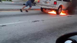 Person Gives Burning SUV a Push