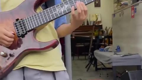 Talented boy plays the guitar