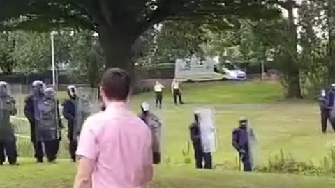 Patrick Quinlan from the National Party addressing the riot squad in defiance in Dublin