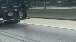 Man Hitches a Ride on a Semi