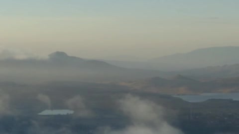 Aerial tour above a cloudy natural landscape