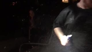 guy in black shirt get beer in face from motorcycle