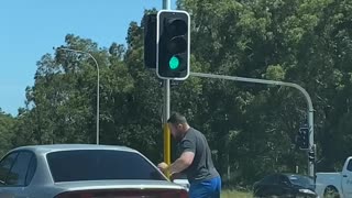 Angry Man Attacks Car at Intersection