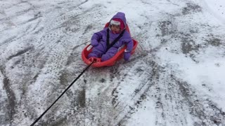 RC Car Tows Baby In Sled Around A Snowy Yard