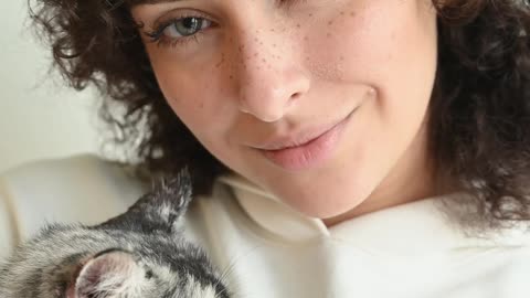 Woman cuddling her cat 4K
