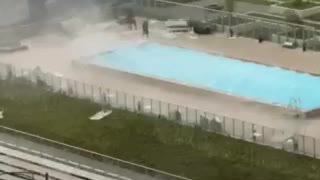 Pool Workers Scramble to Tie down Furniture during Intense Winds